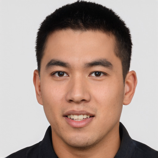 Joyful asian young-adult male with short  brown hair and brown eyes