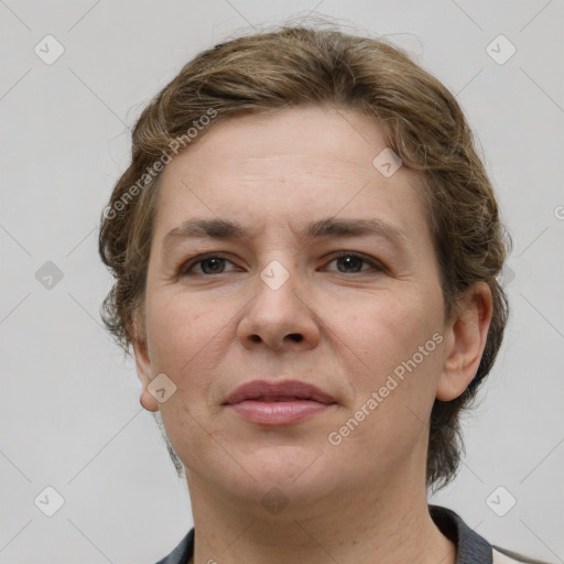 Joyful white adult female with medium  brown hair and grey eyes