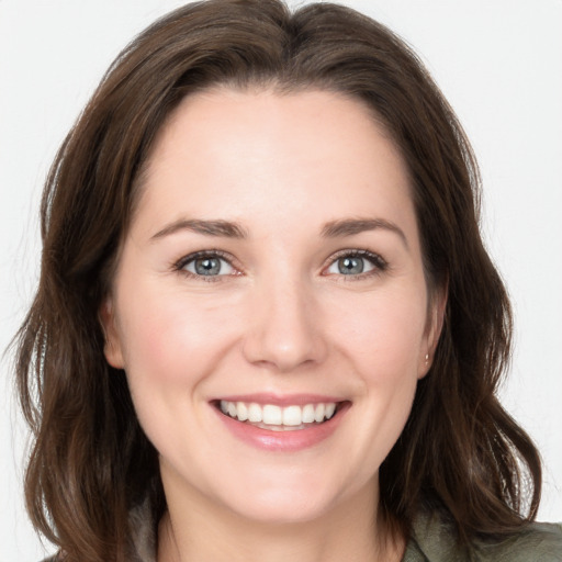 Joyful white young-adult female with medium  brown hair and grey eyes