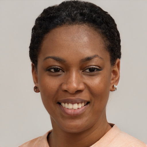 Joyful black young-adult female with short  black hair and brown eyes