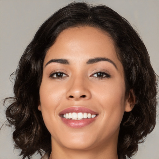 Joyful white young-adult female with medium  brown hair and brown eyes