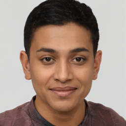 Joyful latino young-adult male with short  brown hair and brown eyes