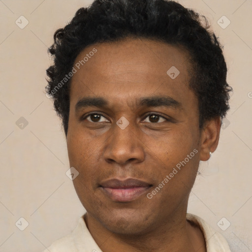 Joyful black young-adult male with short  black hair and brown eyes