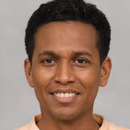 Joyful latino young-adult male with short  black hair and brown eyes