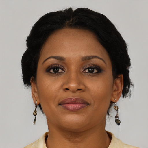 Joyful black adult female with short  brown hair and brown eyes