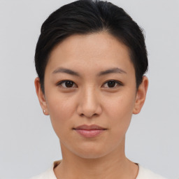 Joyful asian young-adult female with short  black hair and brown eyes