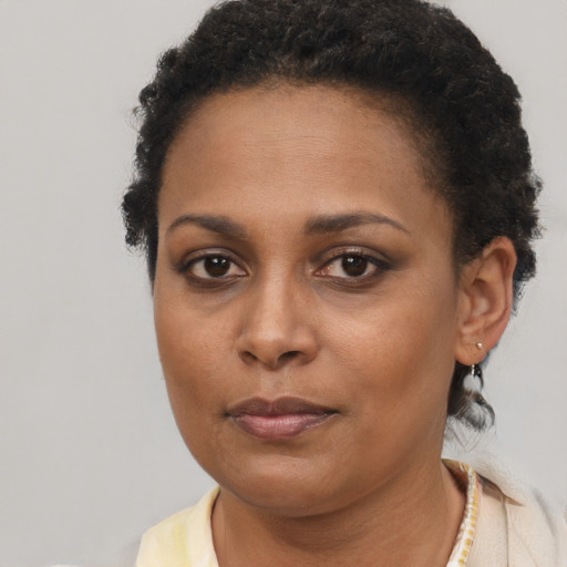 Neutral black young-adult female with short  brown hair and brown eyes