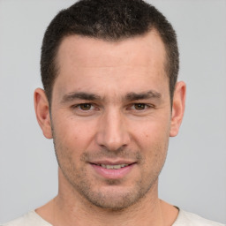 Joyful white young-adult male with short  brown hair and brown eyes