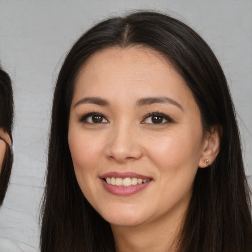 Joyful white young-adult female with long  brown hair and brown eyes