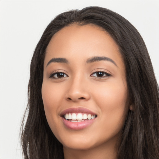 Joyful latino young-adult female with long  black hair and brown eyes