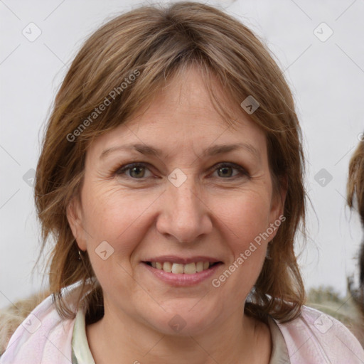 Joyful white adult female with medium  brown hair and brown eyes