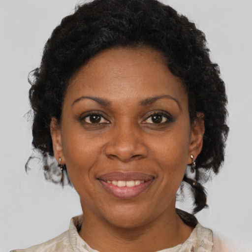 Joyful black adult female with short  brown hair and brown eyes