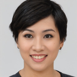 Joyful asian young-adult female with medium  black hair and brown eyes