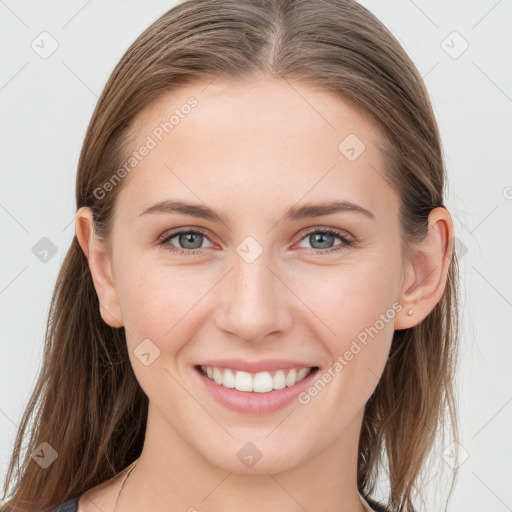 Joyful white young-adult female with long  brown hair and grey eyes