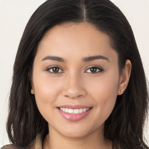 Joyful white young-adult female with long  brown hair and brown eyes