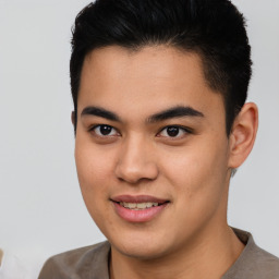 Joyful asian young-adult male with short  brown hair and brown eyes