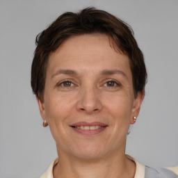 Joyful white adult female with short  brown hair and grey eyes