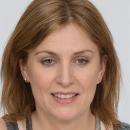 Joyful white adult female with medium  brown hair and grey eyes