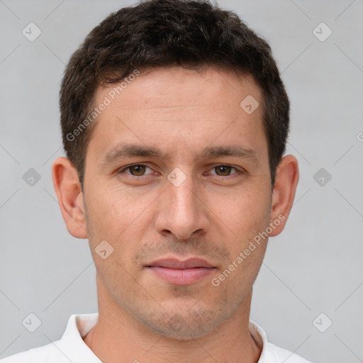 Joyful white young-adult male with short  brown hair and brown eyes