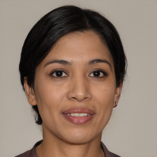 Joyful latino young-adult female with medium  black hair and brown eyes