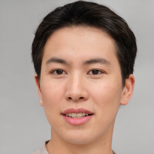 Joyful asian young-adult male with short  brown hair and brown eyes