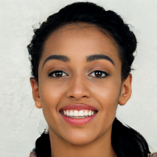 Joyful latino young-adult female with long  black hair and brown eyes