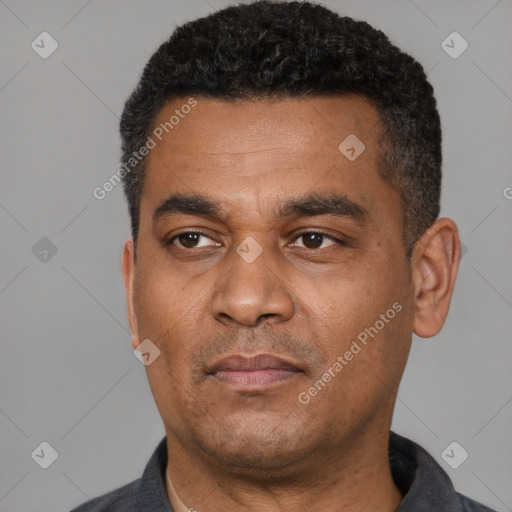 Neutral latino adult male with short  black hair and brown eyes