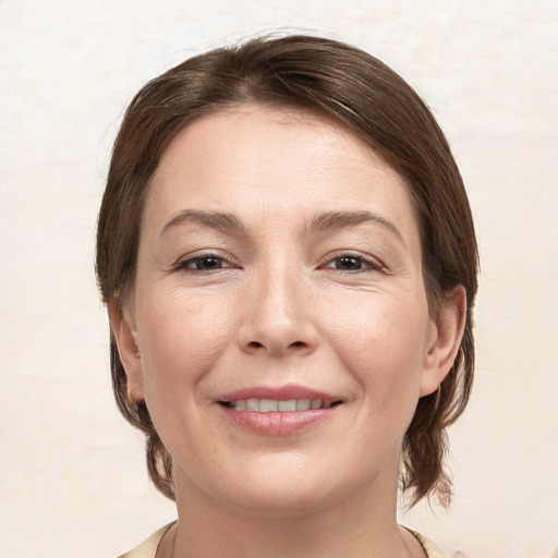 Joyful white young-adult female with medium  brown hair and brown eyes