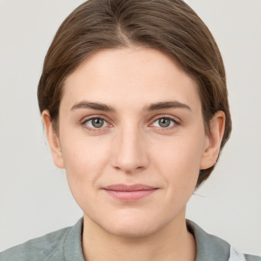 Joyful white young-adult female with medium  brown hair and grey eyes