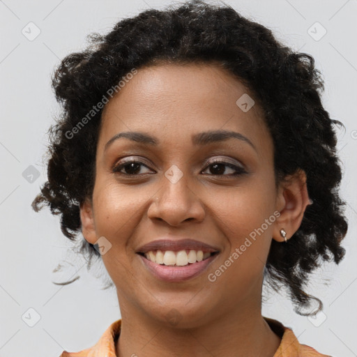 Joyful black young-adult female with long  brown hair and brown eyes