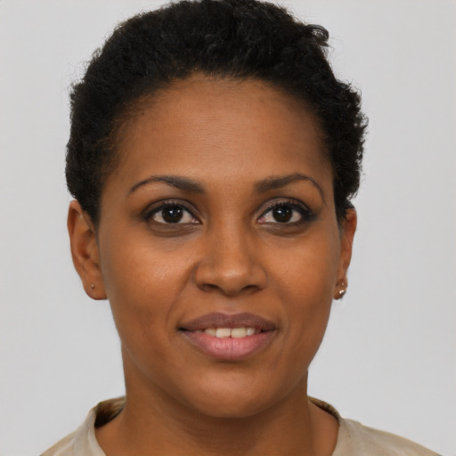 Joyful black young-adult female with short  brown hair and brown eyes