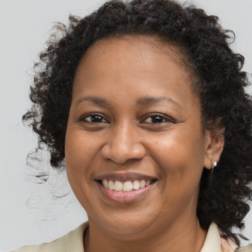 Joyful black young-adult female with medium  brown hair and brown eyes