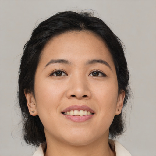 Joyful asian young-adult female with medium  brown hair and brown eyes