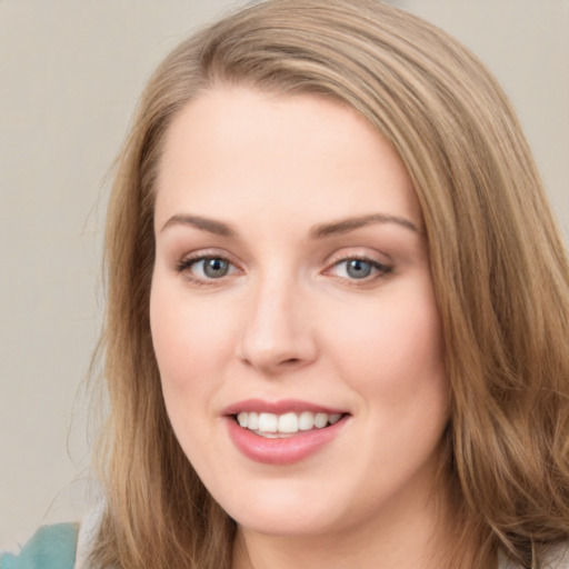 Joyful white young-adult female with long  brown hair and blue eyes