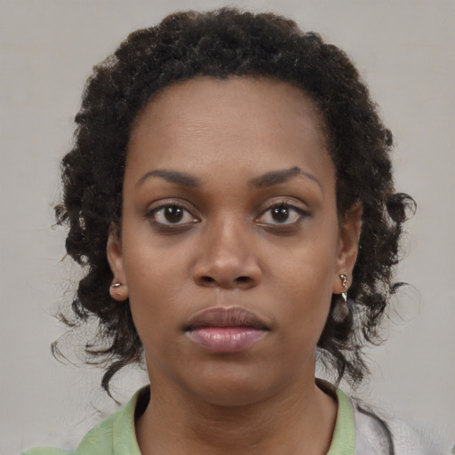 Neutral black young-adult female with medium  brown hair and brown eyes