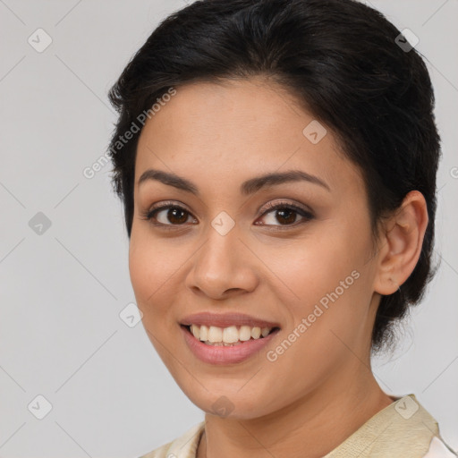 Joyful latino young-adult female with medium  brown hair and brown eyes