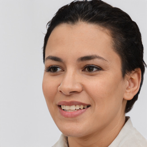 Joyful black young-adult female with short  brown hair and brown eyes