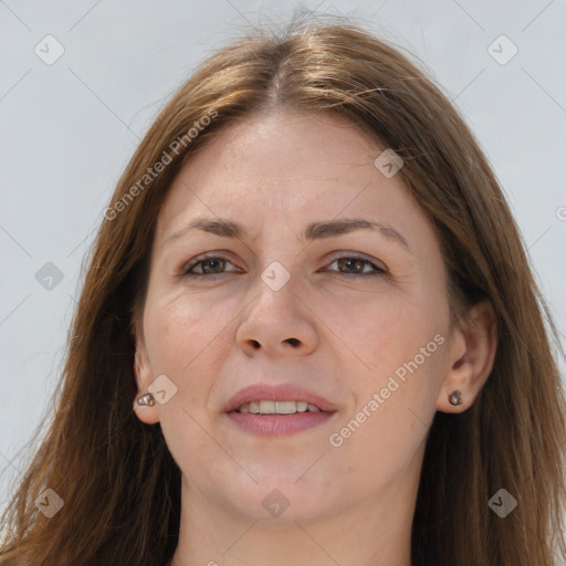 Joyful white adult female with long  brown hair and grey eyes