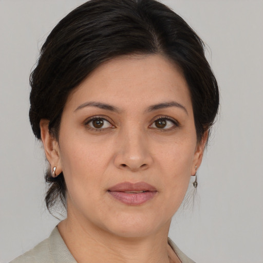 Joyful asian adult female with medium  brown hair and brown eyes