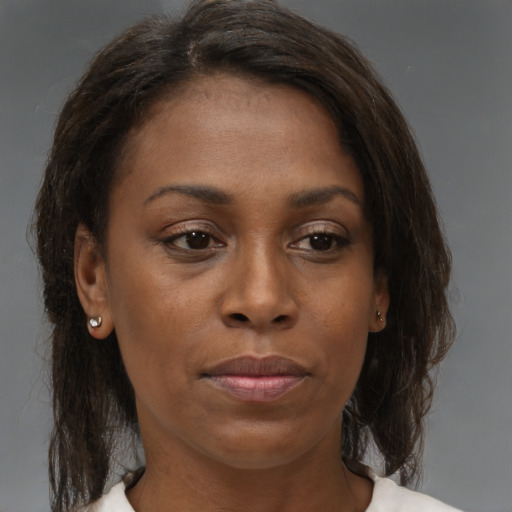Joyful black young-adult female with medium  brown hair and brown eyes