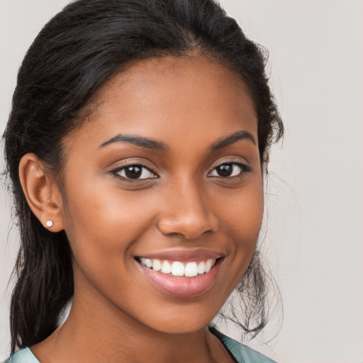 Joyful latino young-adult female with long  brown hair and brown eyes