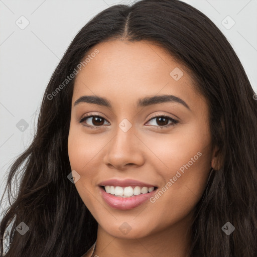 Joyful latino young-adult female with long  brown hair and brown eyes