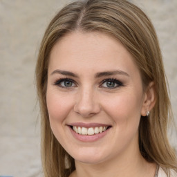 Joyful white young-adult female with long  brown hair and green eyes