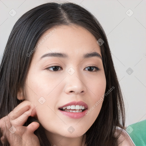 Joyful white young-adult female with long  brown hair and brown eyes