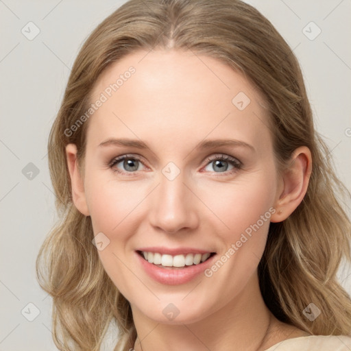 Joyful white young-adult female with long  brown hair and blue eyes