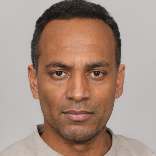 Neutral black adult male with short  black hair and brown eyes