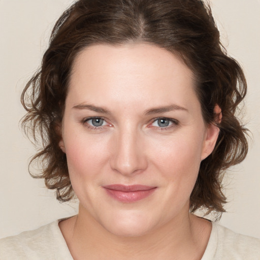 Joyful white young-adult female with medium  brown hair and green eyes