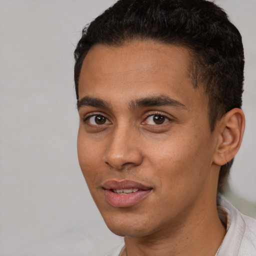 Joyful white young-adult male with short  black hair and brown eyes