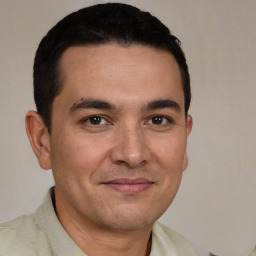 Joyful white young-adult male with short  black hair and brown eyes