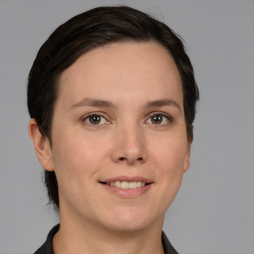 Joyful white young-adult female with short  brown hair and grey eyes